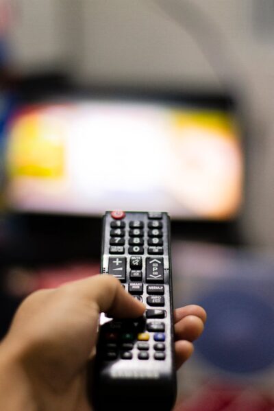 person holding black remote control